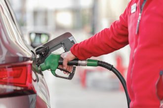 Motorist refuelling a vehicle as Belgium petrol and diesel prices remain elevated.