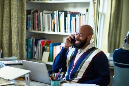 Remote entrepreneur using a laptop to Register UK company online from a home office