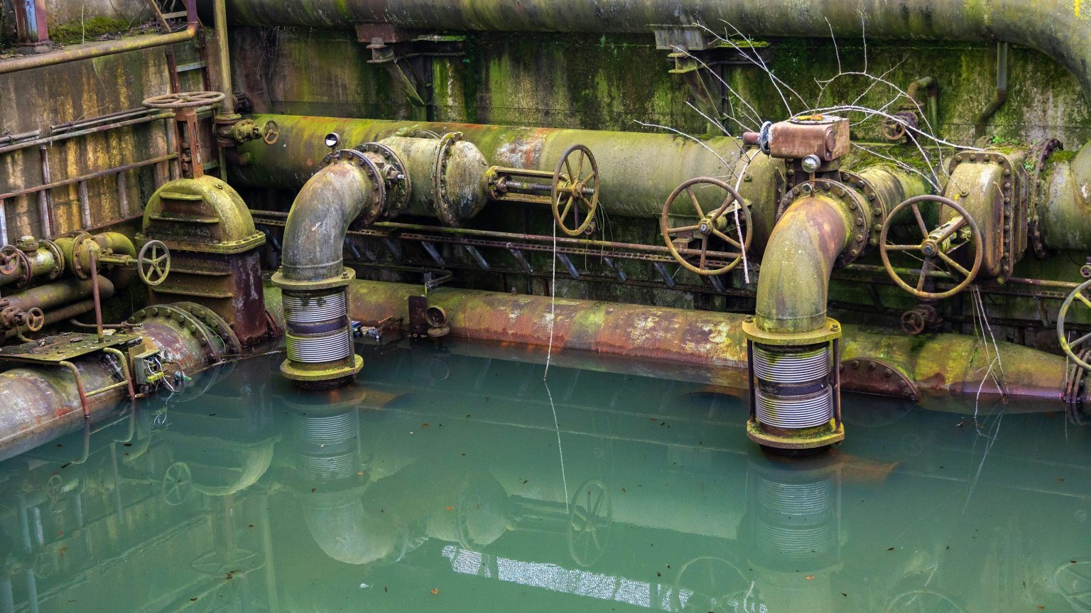 Industrial pipes and water infrastructure illustrating environmental concerns surrounding Brussels PFAS pollution.