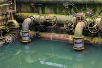 Industrial pipes and water infrastructure illustrating environmental concerns surrounding Brussels PFAS pollution.