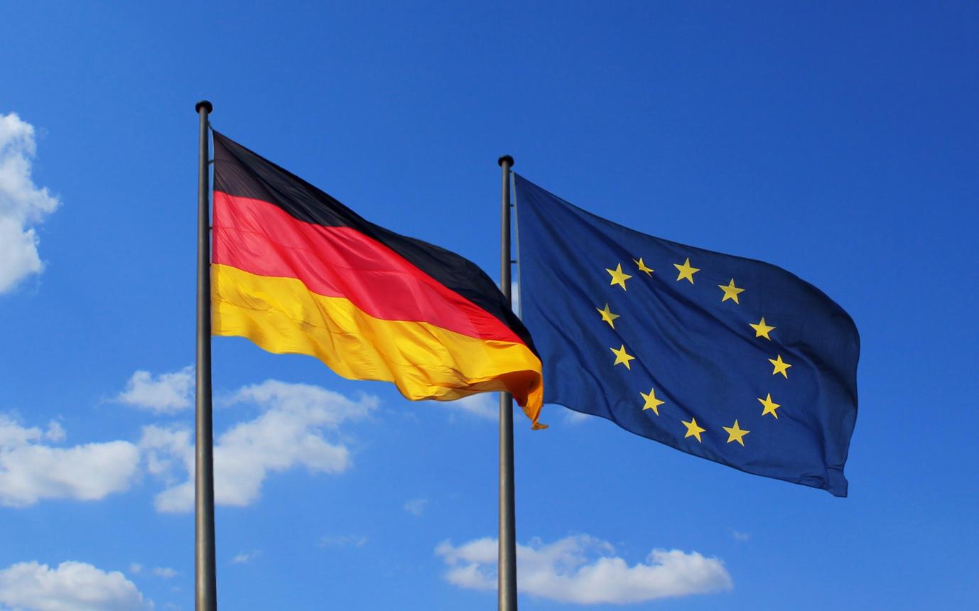 German and European Union flags representing Germany's concerns over EU protectionism and international trade.