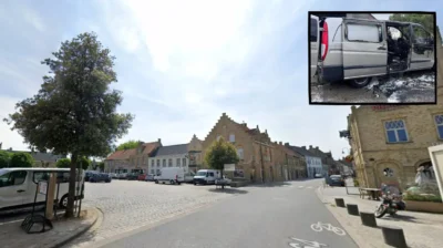 Lo-Reninge staff push the burning van away from the building