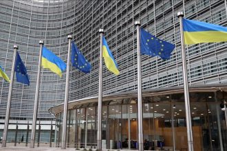 EU defence readiness as EU and Ukrainian flags fly outside the European Commission in Brussels