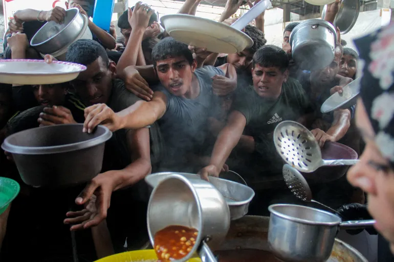 Palestinians gather to receive food