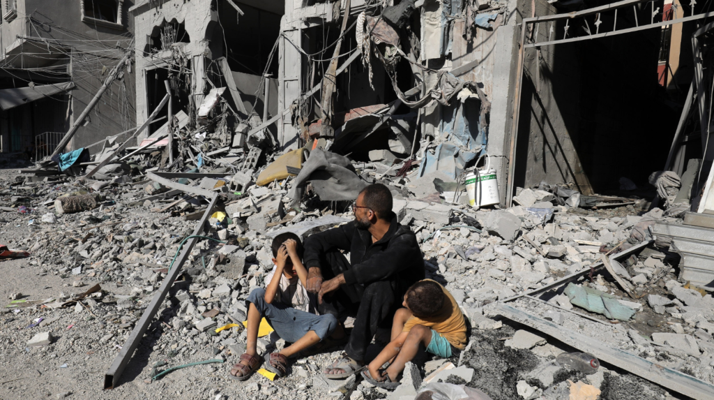 Palestinians search a house after an Israeli air strike, in the city of Rafah, south of the Gaza Strip