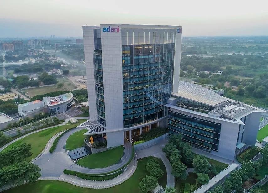 India corporate restructuring news showing Gautam Adani leading business restructuring efforts