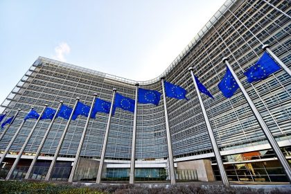 EU Russia sanctions talks in Brussels as EU and Ukrainian flags fly outside the Berlaymont