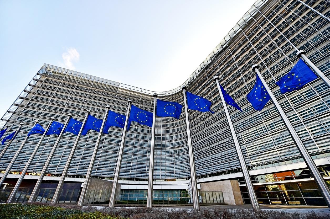 EU Russia sanctions talks in Brussels as EU and Ukrainian flags fly outside the Berlaymont