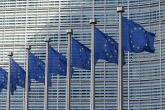 European Union flags in Brussels representing EU Ukraine aid and European defence cooperation.