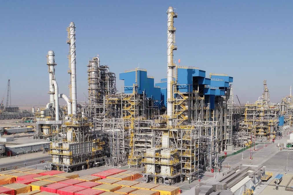 Middle East oil crisis impacting Saudi oil refinery operations at night