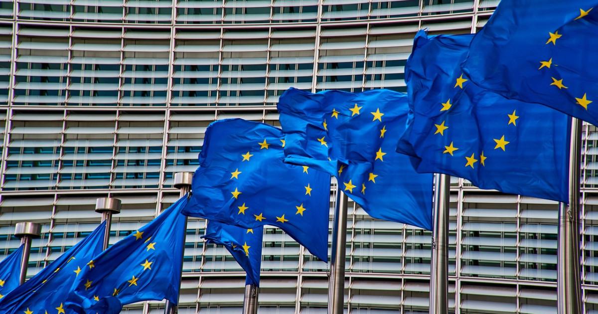 Russia sanctions expansion discussed in Brussels as EU flags fly outside the European Commission.