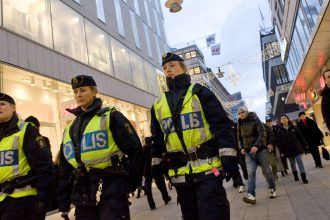Sweden public safety with Swedish police officers monitoring security in Stockholm city center