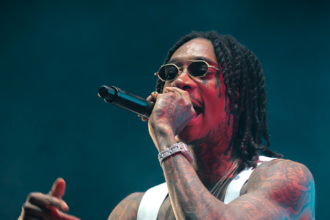 Wiz Khalifa performing on stage in 2025