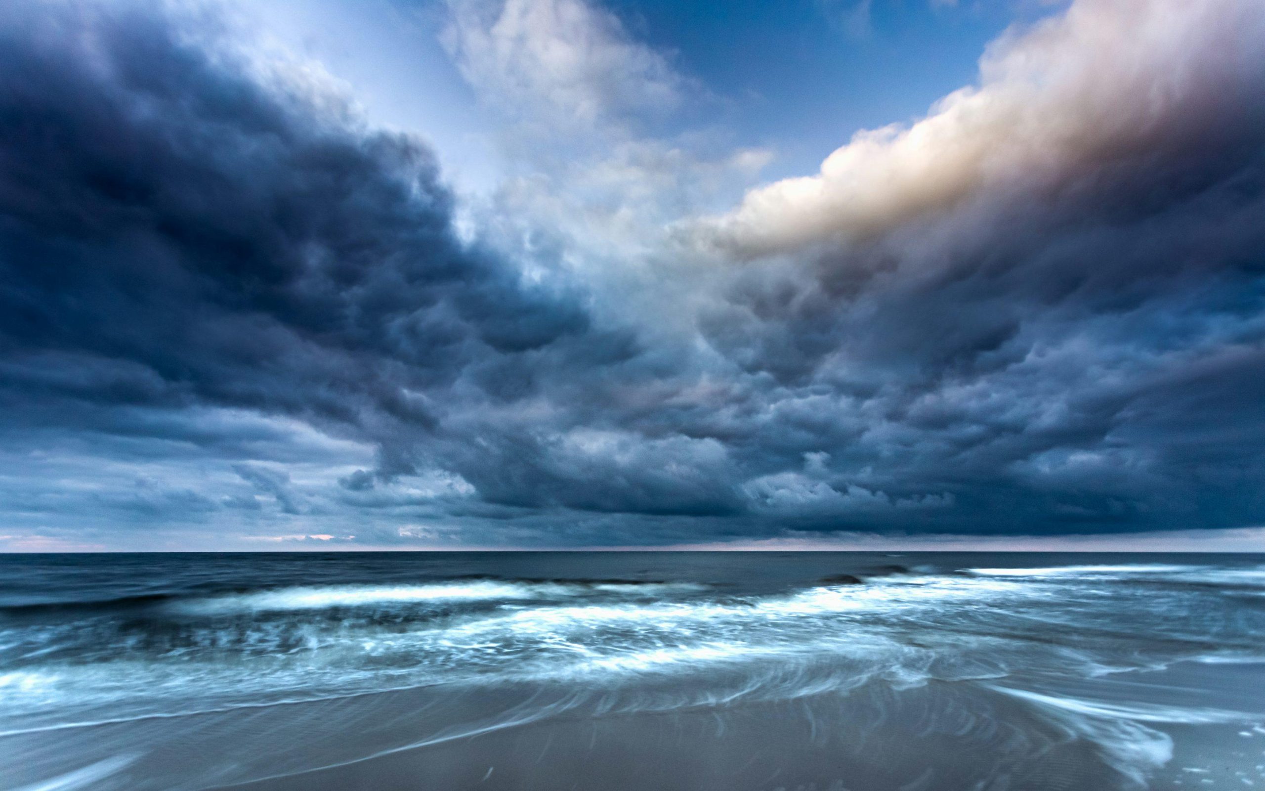 Cyclone Arnab weather illustration featuring dark storm clouds gathering above rough ocean waters.