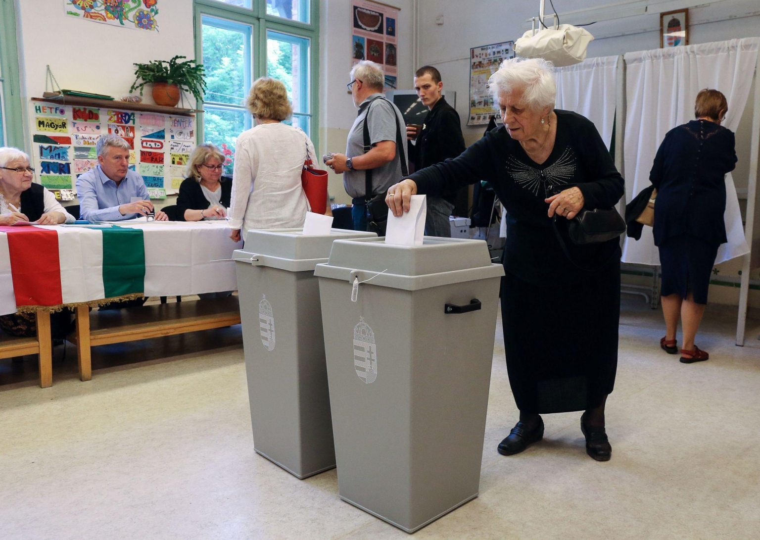 Hungarian voters participating in national election at polling station