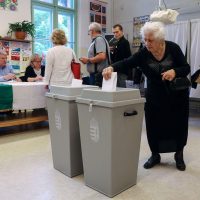 Hungarian voters participating in national election at polling station