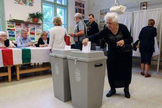 Hungarian voters participating in national election at polling station