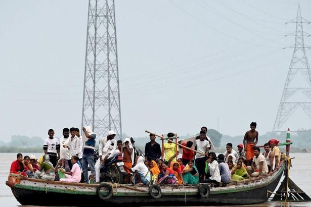 People stranded during flooding in Bihar, illustrating the dangers associated with India cyclone evacuations.