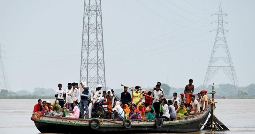 People stranded during flooding in Bihar, illustrating the dangers associated with India cyclone evacuations.