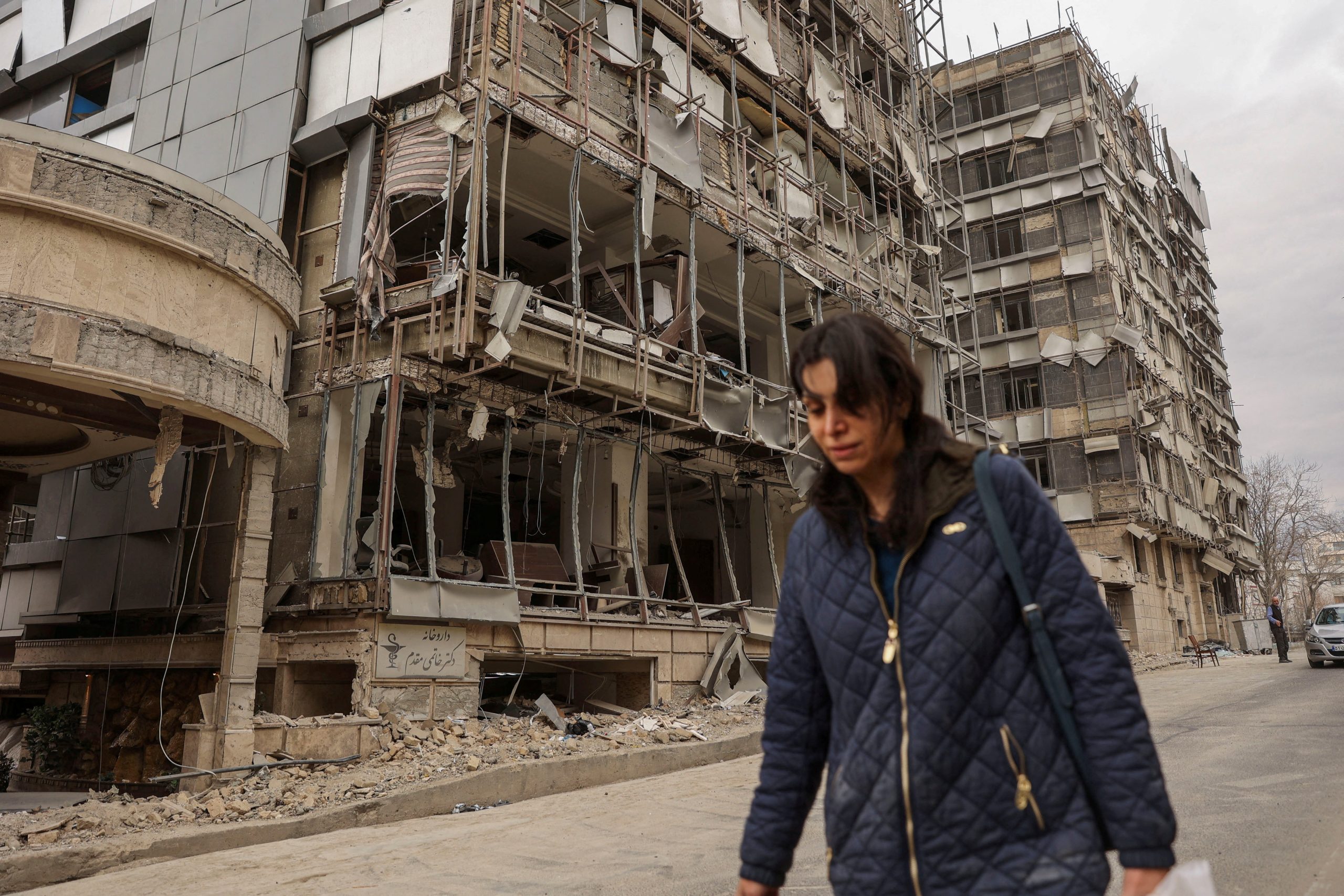 families evacuating homes during Tehran residential attack emergency