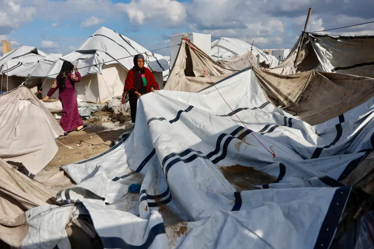 Gaza civilians winter storms damage fragile shelters