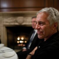 Jeffrey Epstein seated during a public appearance before his arrest in the sex trafficking case