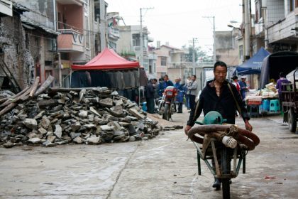 Gaoxian County earthquake rescue teams inspecting damaged area in Sichuan