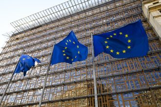 European Union flags outside EU headquarters during Iran sanctions announcement