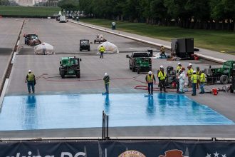 Lincoln Memorial Reflecting Pool showing blue paint visible during ongoing cleanup operations in Washington, D.C.