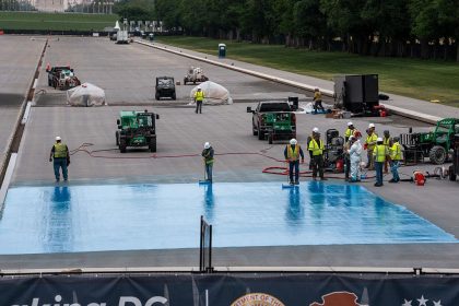 Lincoln Memorial Reflecting Pool showing blue paint visible during ongoing cleanup operations in Washington, D.C.