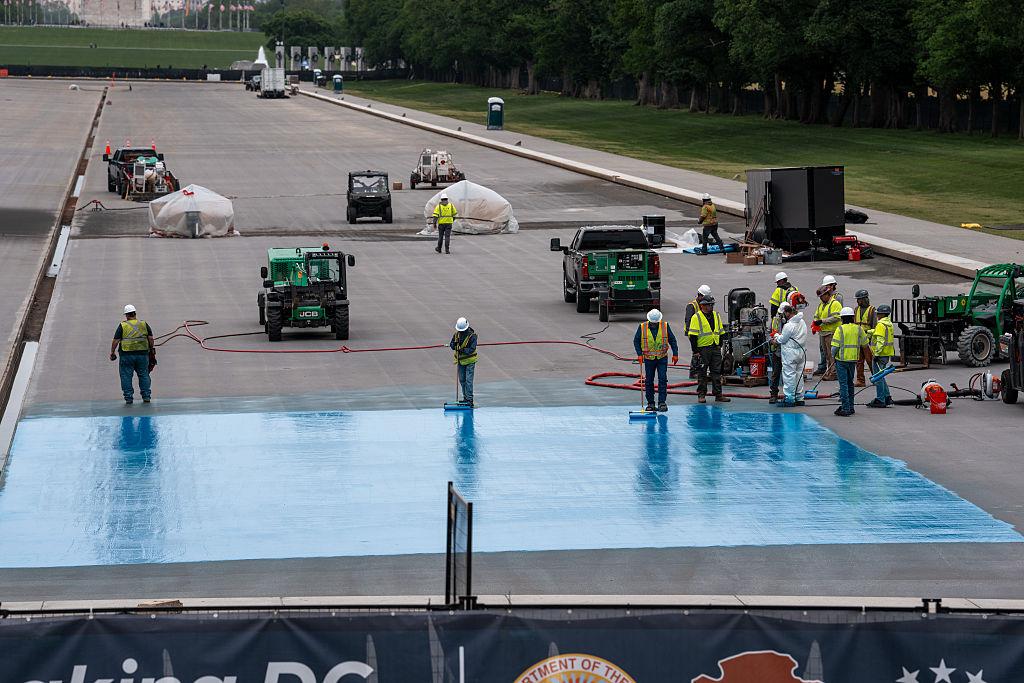 Lincoln Memorial Reflecting Pool showing blue paint visible during ongoing cleanup operations in Washington, D.C.