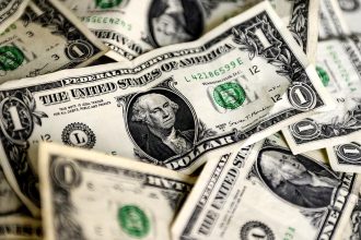 US dollar notes representing global currency markets and inflation concerns.