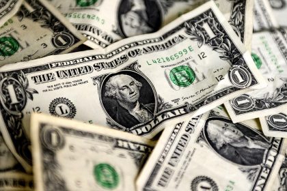 US dollar notes representing global currency markets and inflation concerns.
