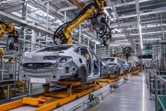 Vehicle manufacturing assembly line illustrating the impact of EU-China trade restrictions on European carmakers.
