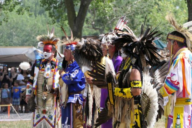 Mohawk Nation community members wearing traditional regalia during a cultural event