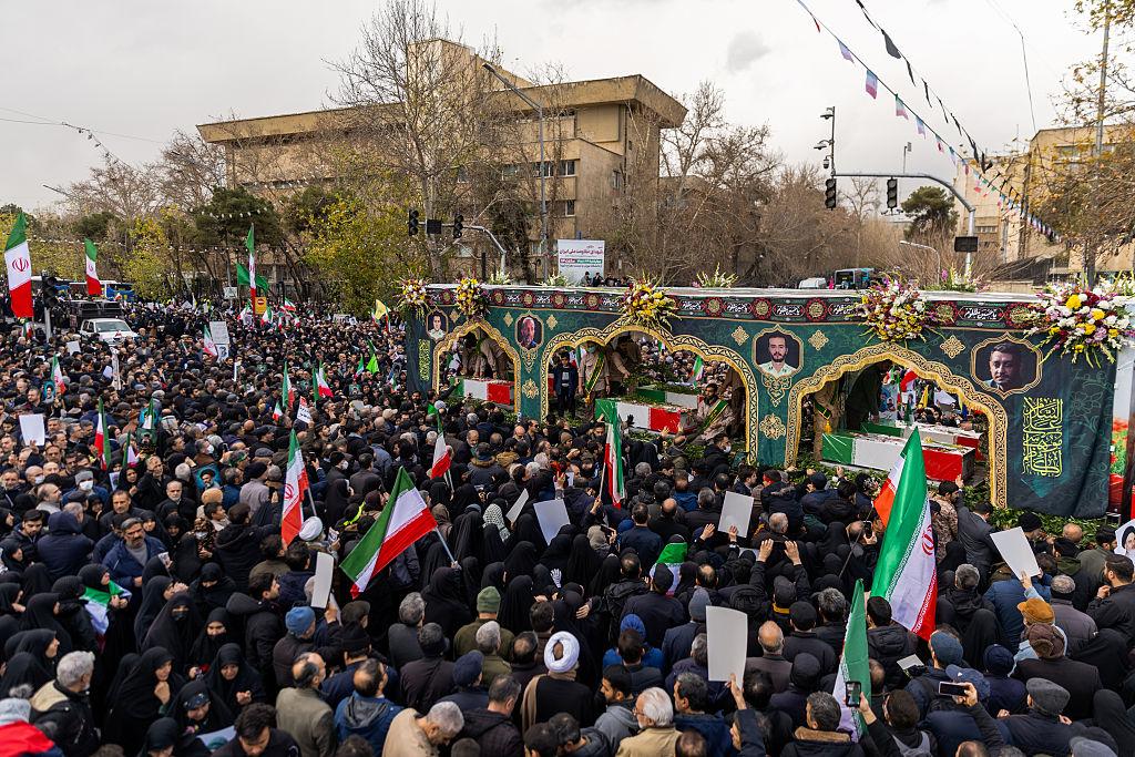Iran funeral security chiefs public mourning in Tehran streets with flags and portraits