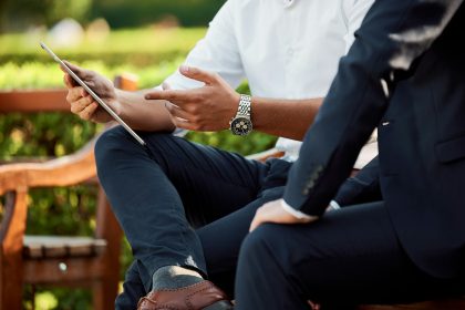 Business professionals using a crisis communication strategy to monitor online reputation and digital media
