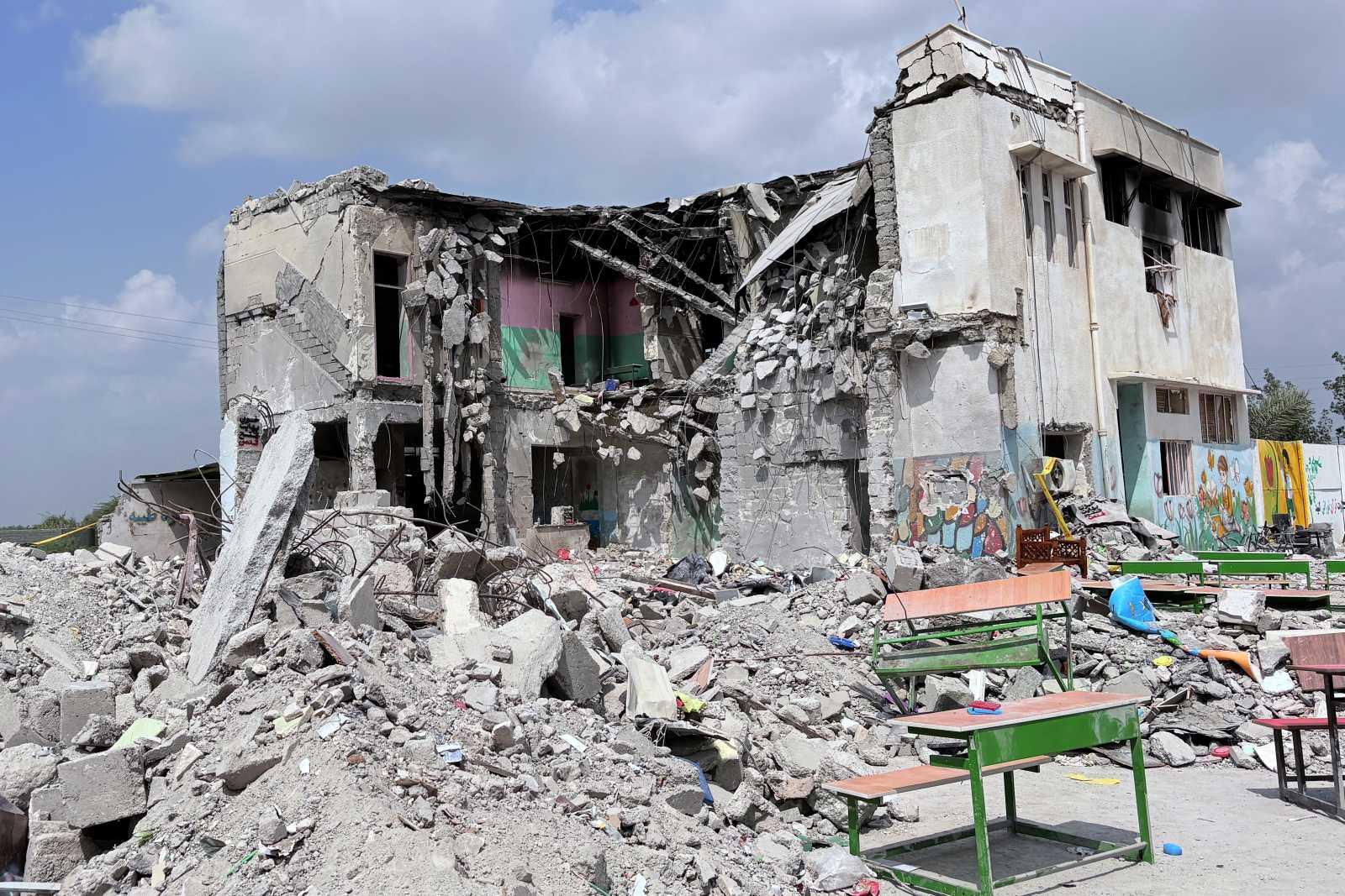 Shahid Beheshti University damage with smoke rising over damaged structures
