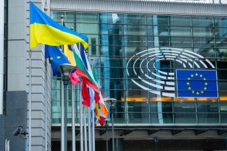 EU Ukraine funding represented by European Union and Ukrainian flags outside the European Commission in Brussels