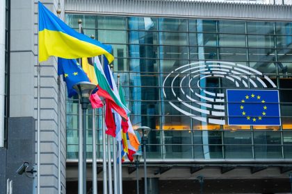 EU Ukraine funding represented by European Union and Ukrainian flags outside the European Commission in Brussels