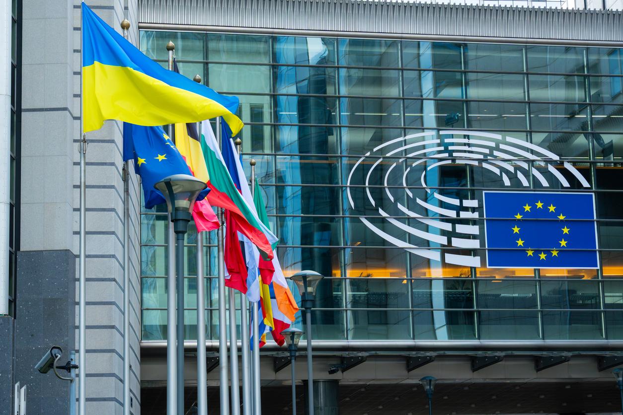 EU Ukraine funding represented by European Union and Ukrainian flags outside the European Commission in Brussels