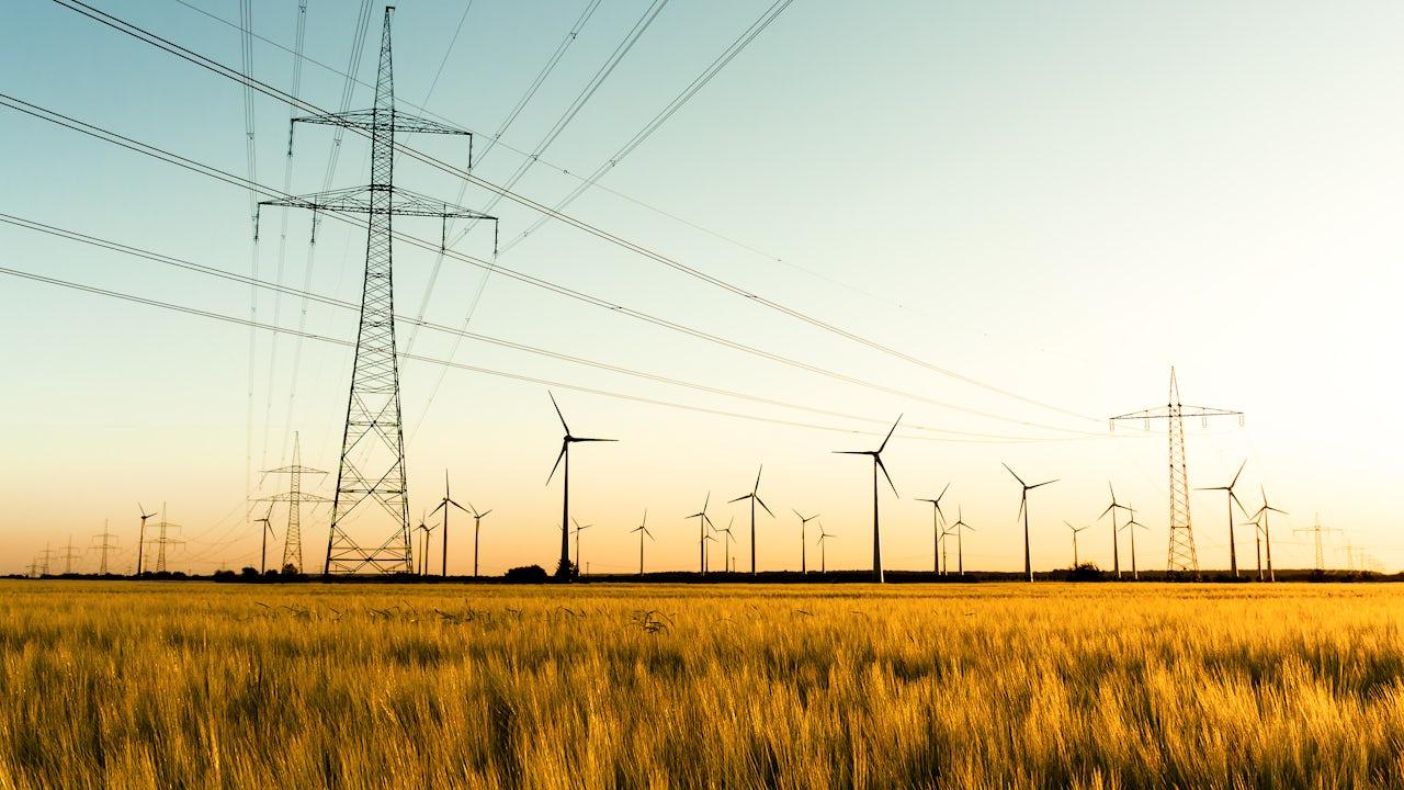 Wind turbines and electricity infrastructure illustrating EU Energy Relief and European energy security.
