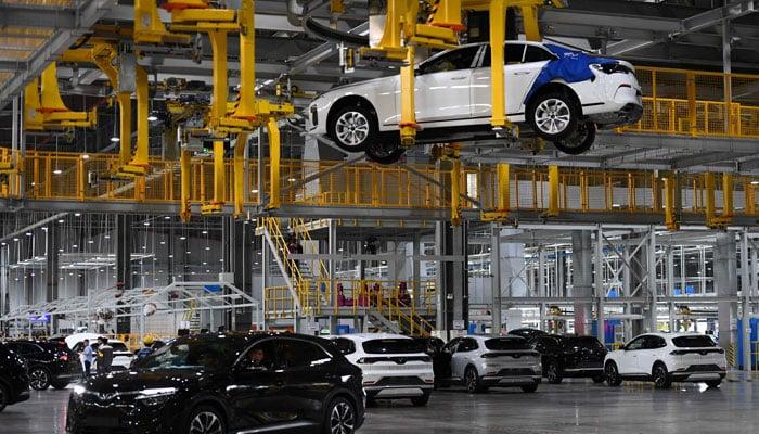 EV innovation China partnership electric vehicle production line at modern factory
