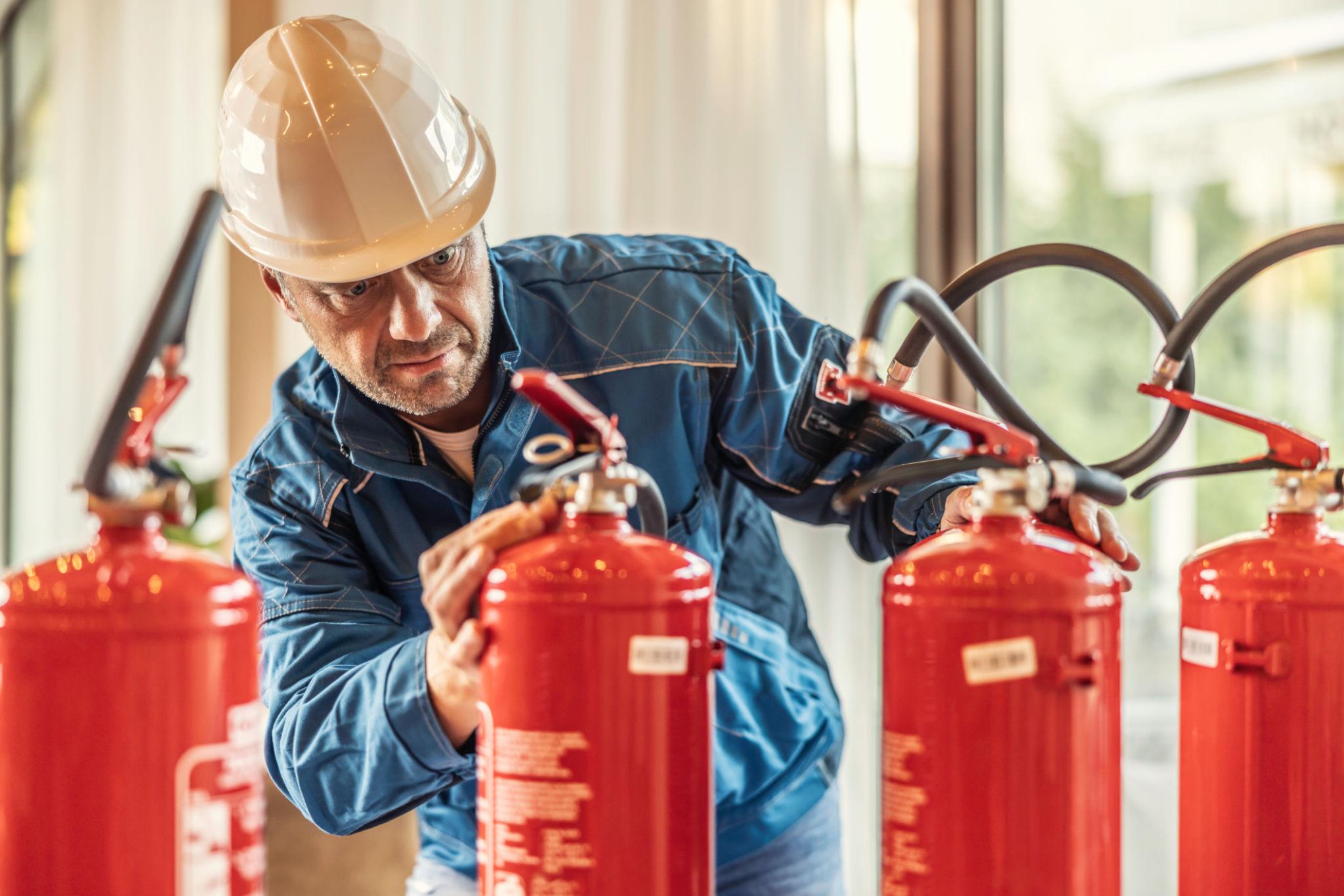 Firefighters responding to an emergency at a hotel under hotel safety regulations review