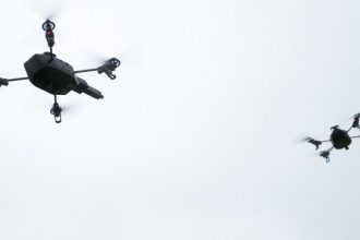 Two unmanned aircraft illustrate Dutch AI drone technology and coordinated aerial systems.