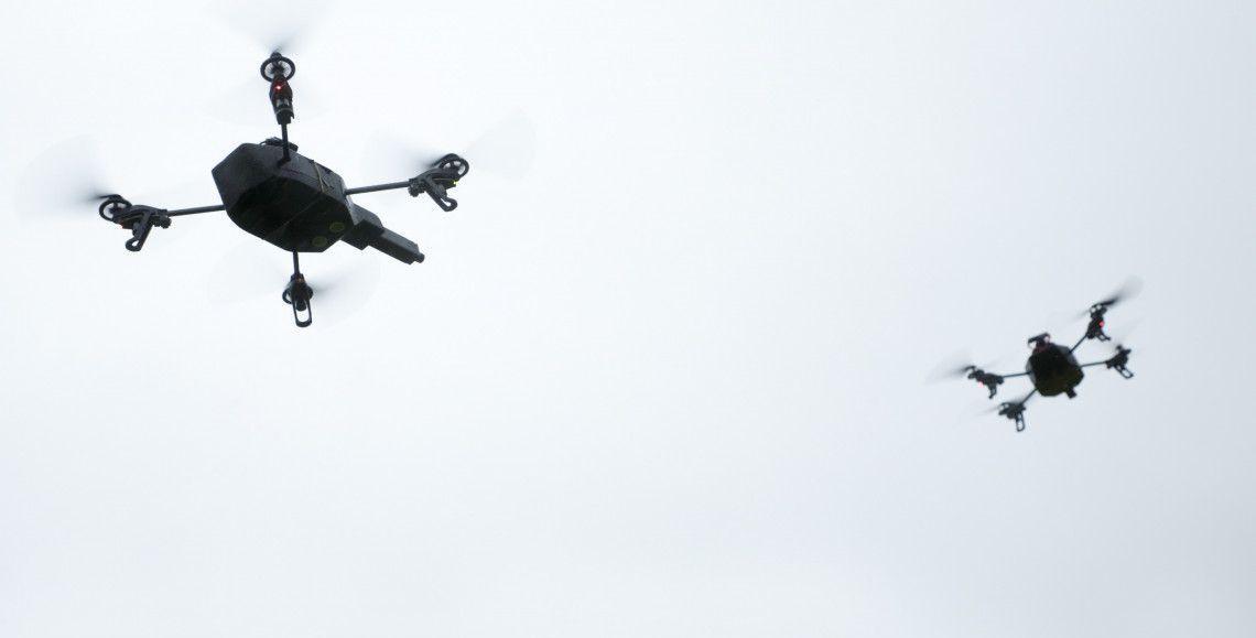 Two unmanned aircraft illustrate Dutch AI drone technology and coordinated aerial systems.