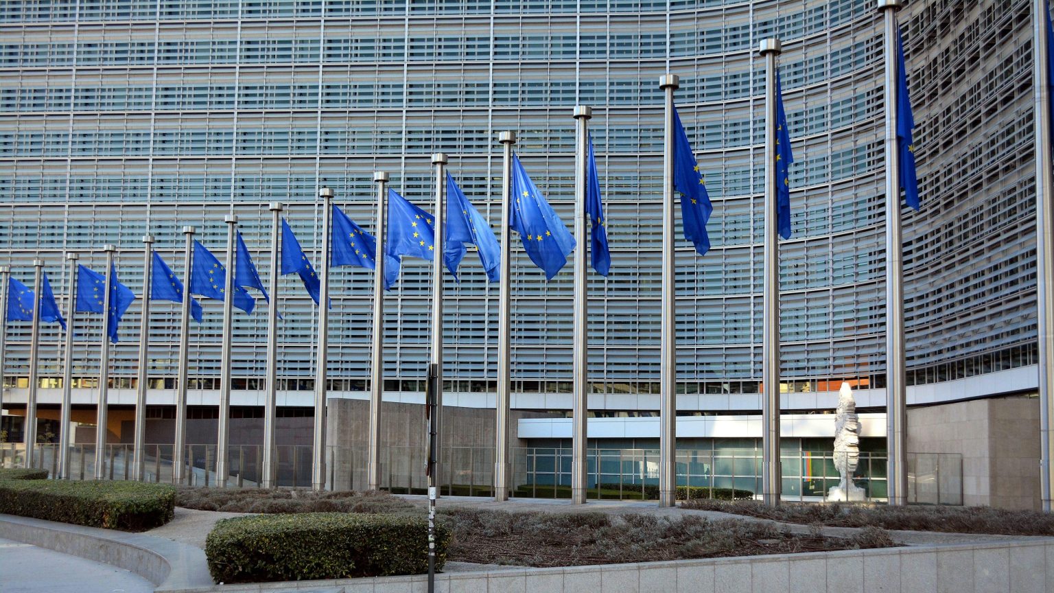 EU-China trade breakthrough and European Union flags outside the European Commission building in Brussels.